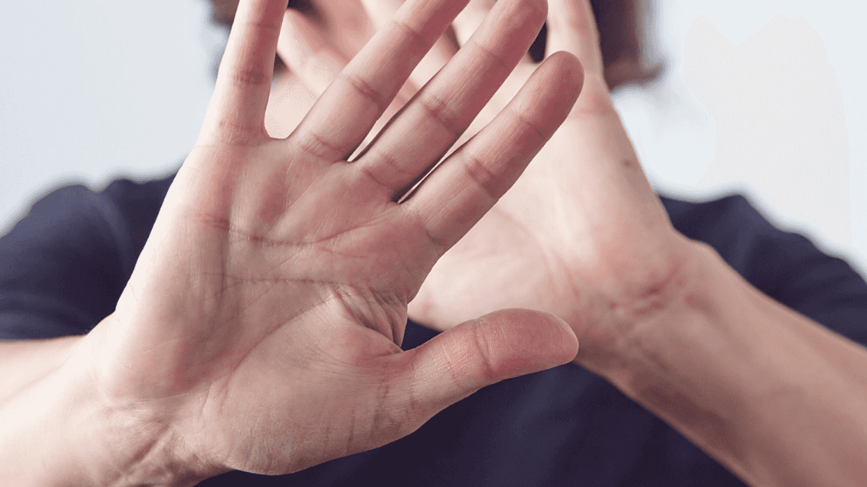 Woman holding her hands in front of the camera.