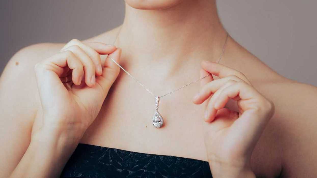 Woman holding necklace