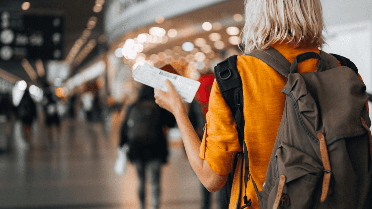 woman holding plane ticket in airport