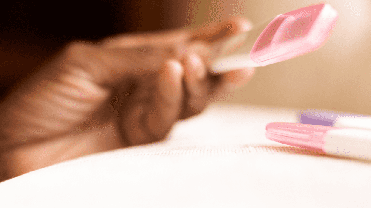 Woman holding pregnancy test