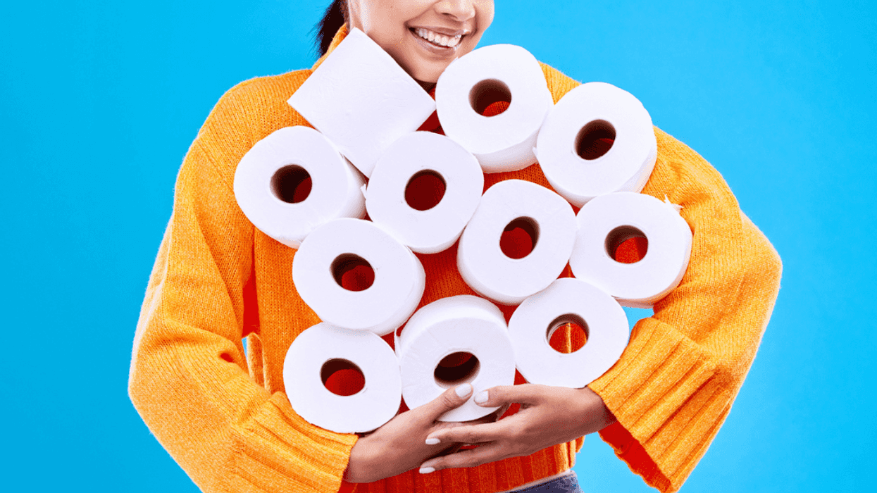 Woman holding rolls of toilet paper