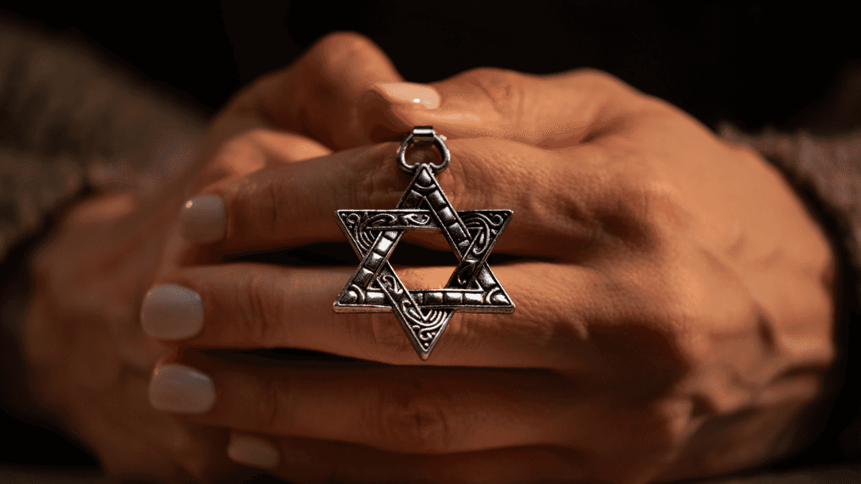 woman holding Star of David pendant