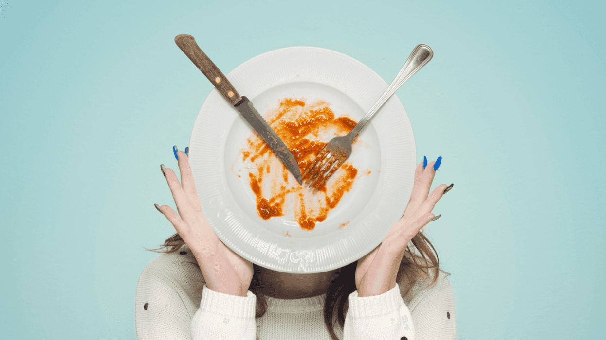 woman holding up a dirty dish