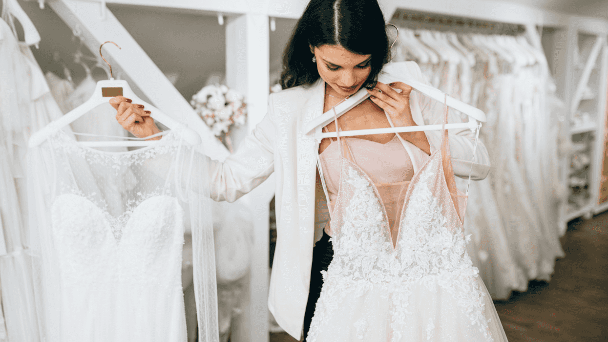 Woman holding wedding dresses