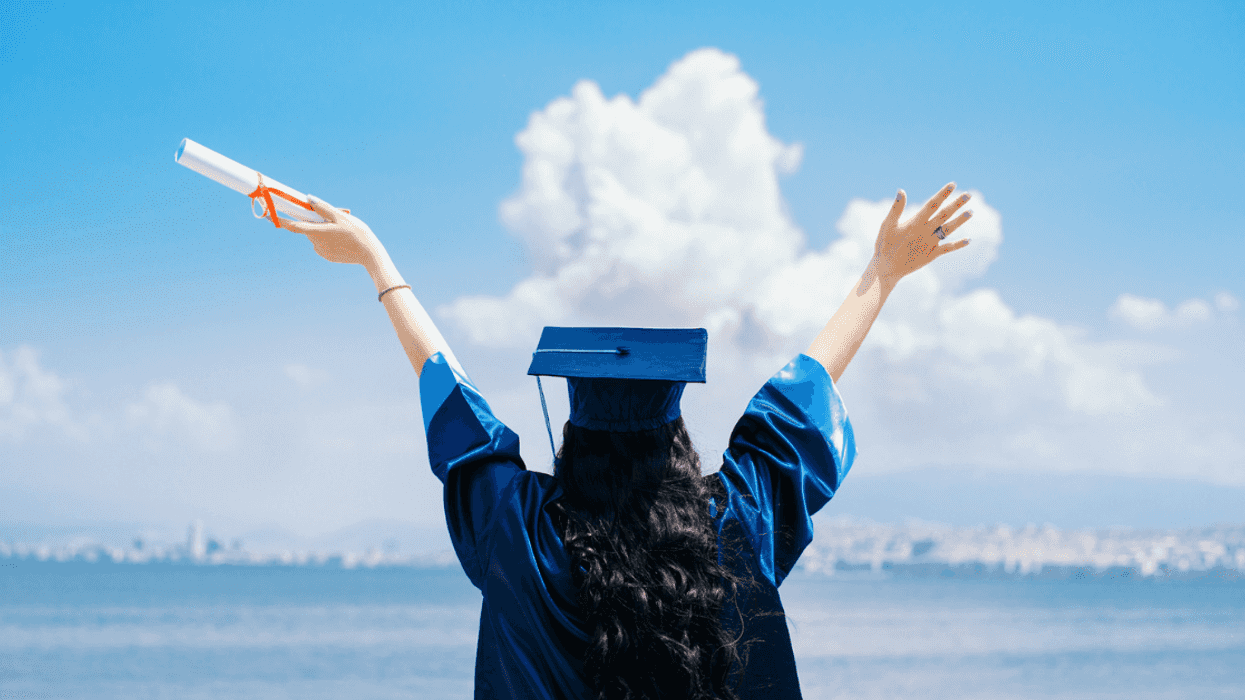Woman in cap and gown holding a diploma