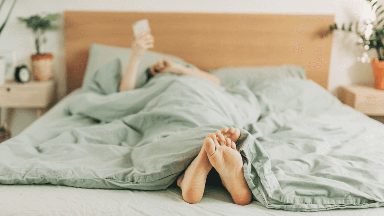 Woman looking at her phone in bed