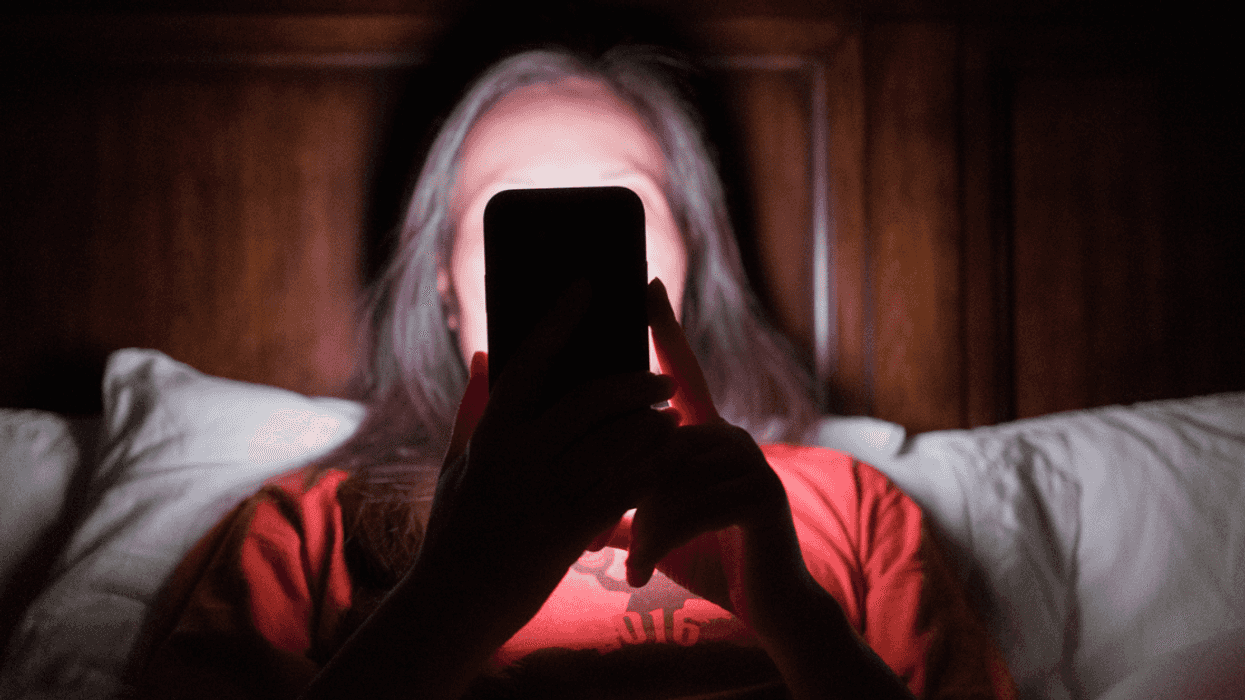 Woman looking at her phone in the dark
