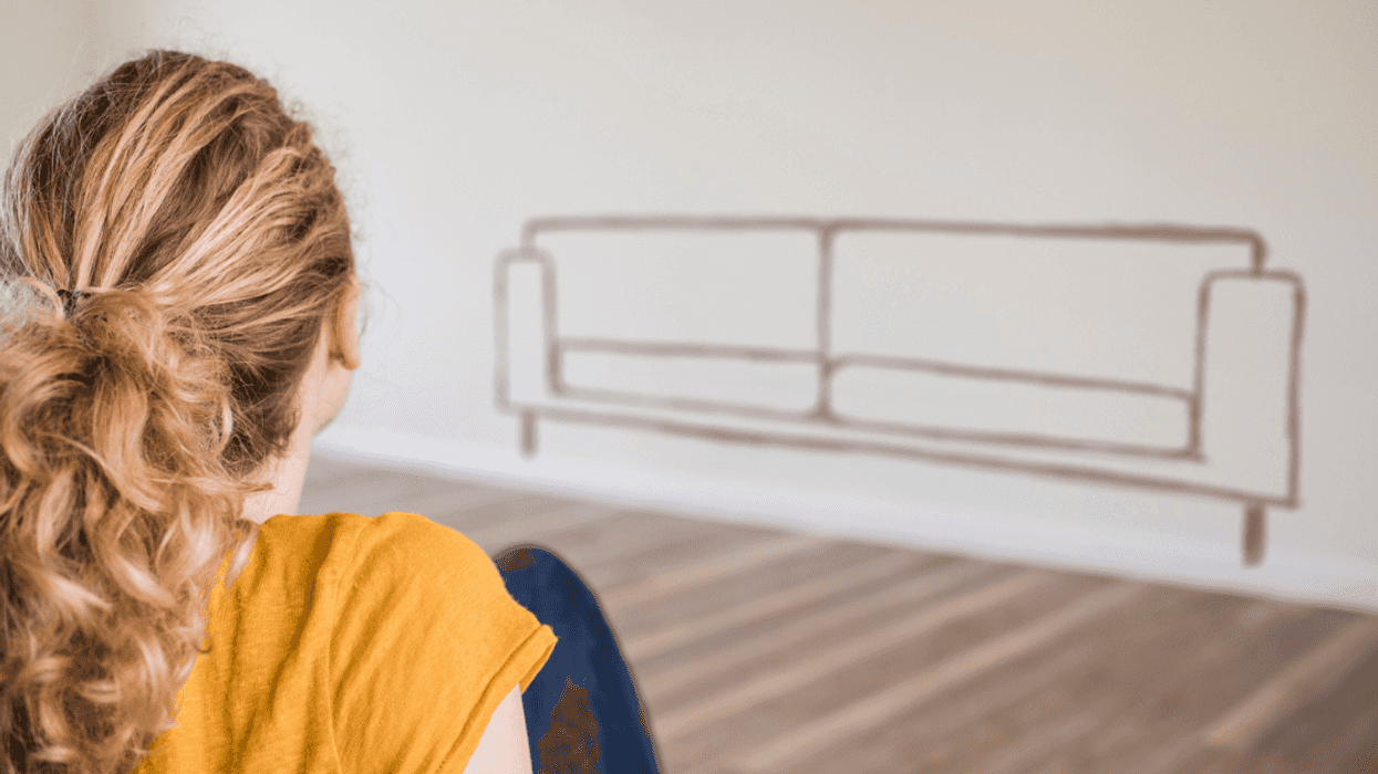 woman looking at silhouette of couch on the wall