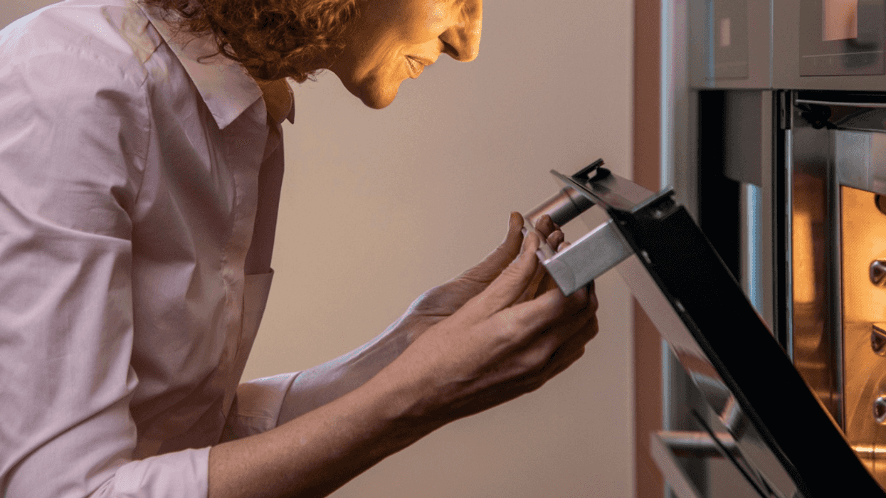 woman looking into oven