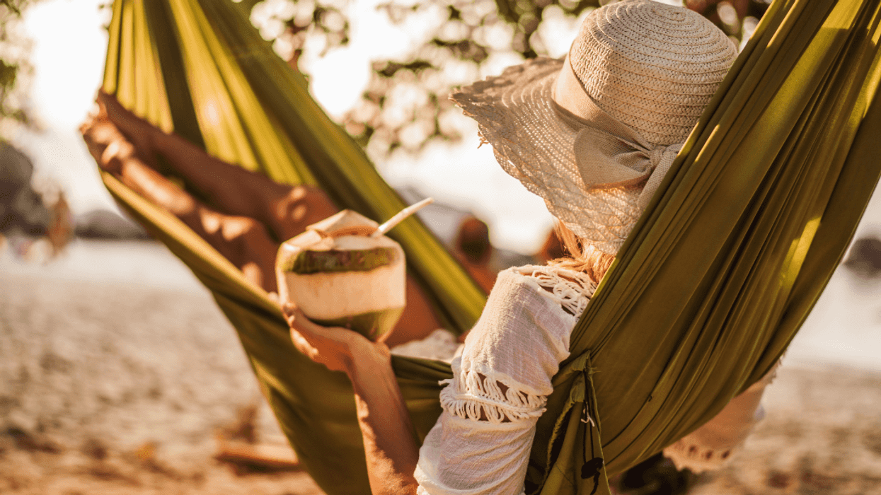 woman lying in a hammock on the beach
