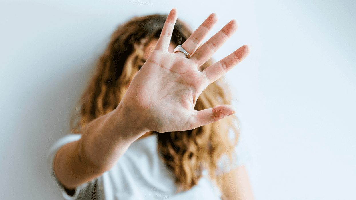 woman making gesture for someone to stop