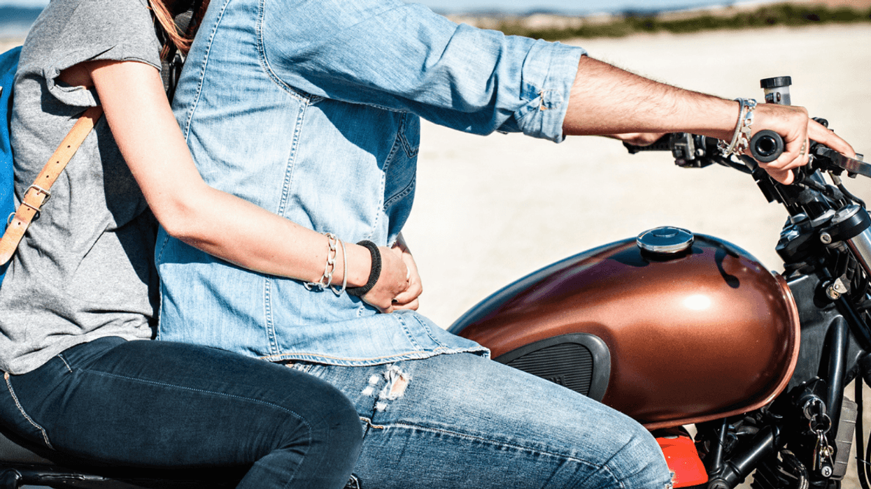 Woman on motorcycle with man