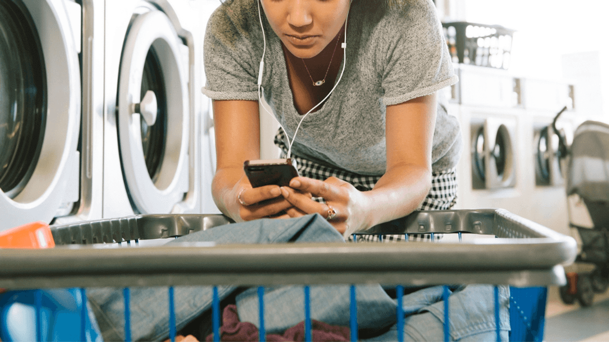 Woman on phone at laundromat