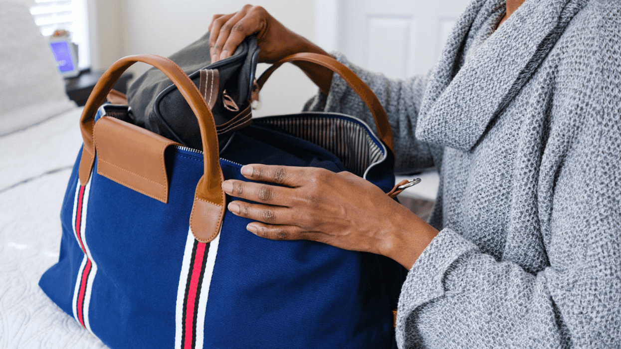 Woman packing a small travel bag