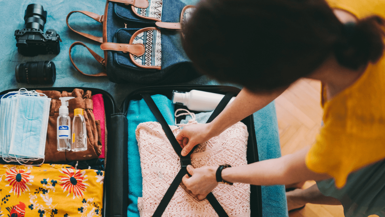 woman packing a suitcase for a trip