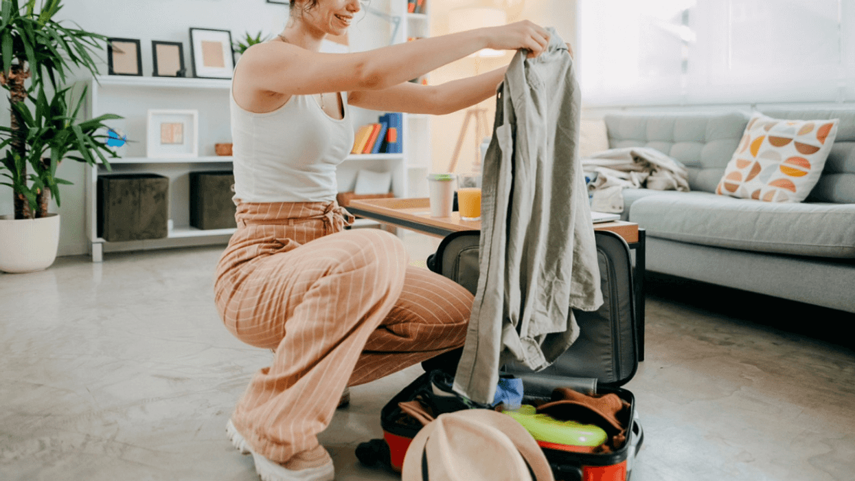 woman packing suitcase for vacation