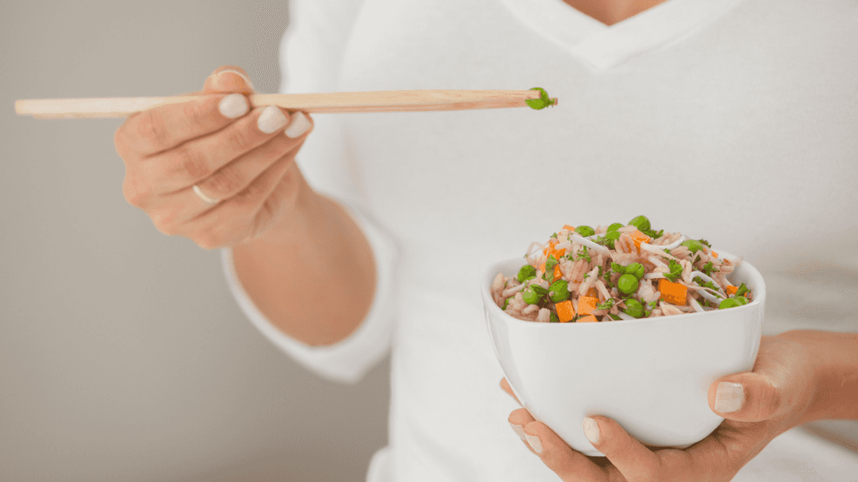 Woman picking peas out of her food.