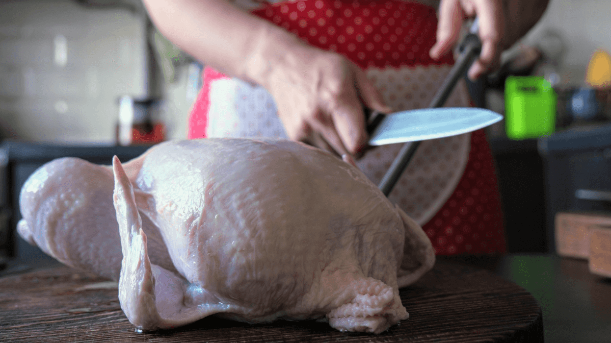 woman preparing whole chicken