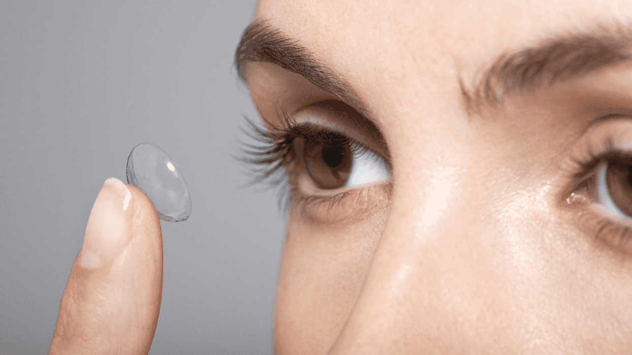 Woman putting in contact lenses