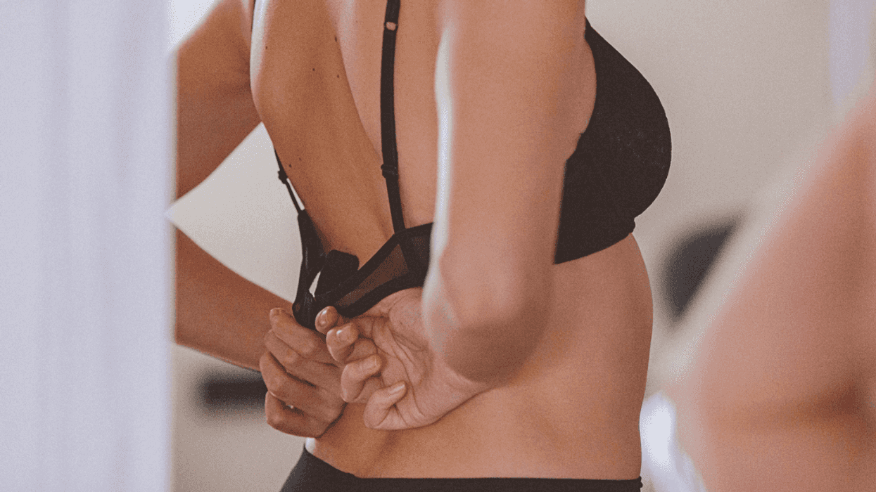 Woman putting on a bra