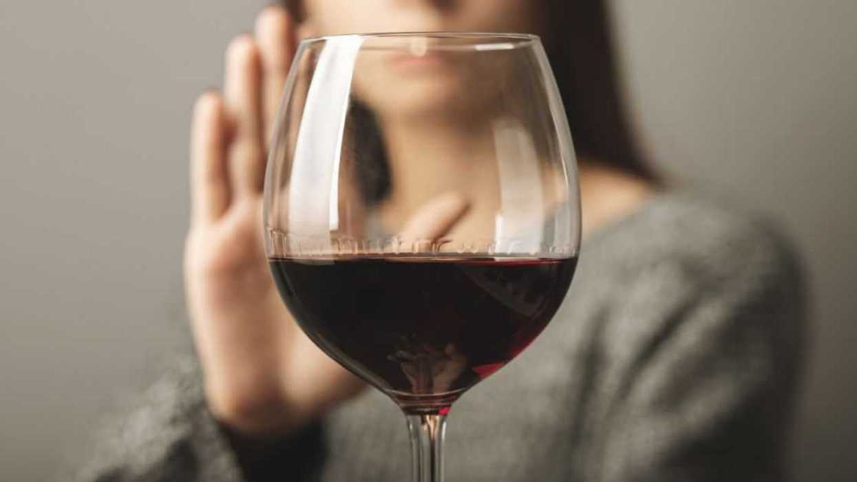 Woman refusing glass of wine