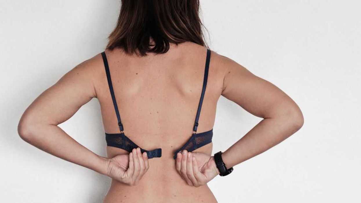 Woman removing her bra