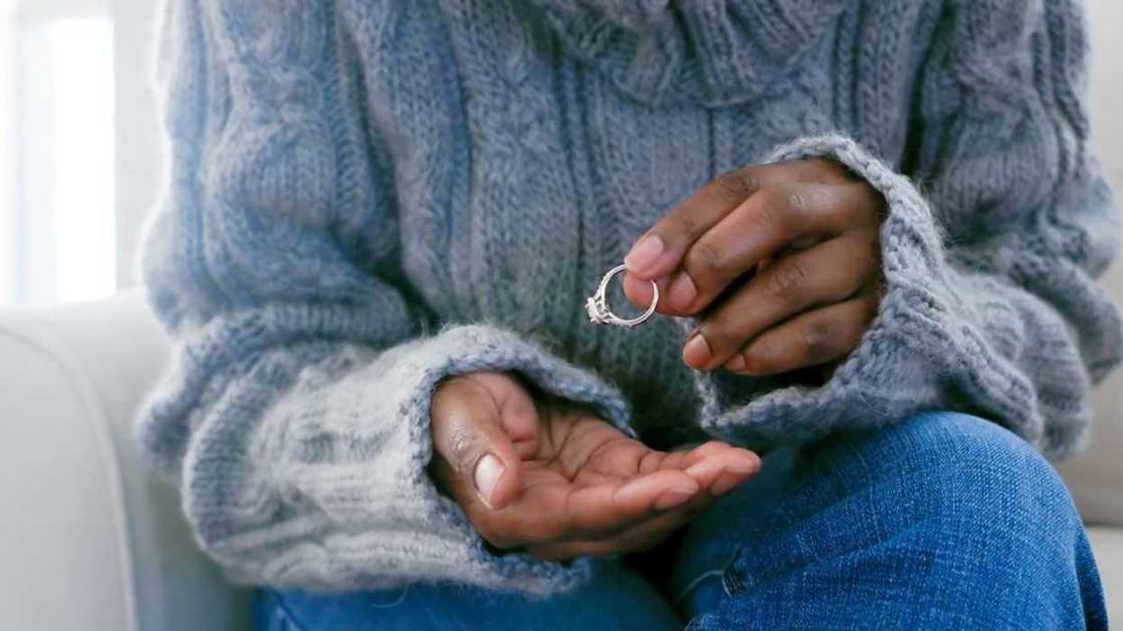 Woman removing ring from finger