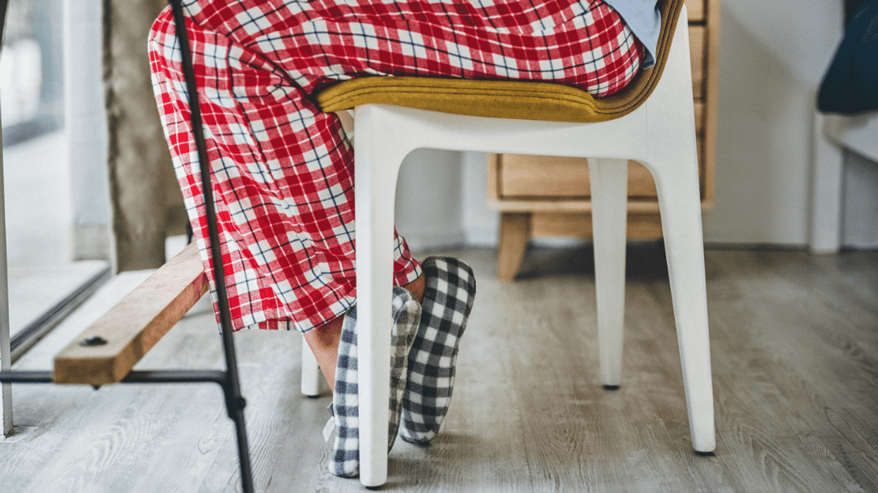 woman seated at desk in pajamas