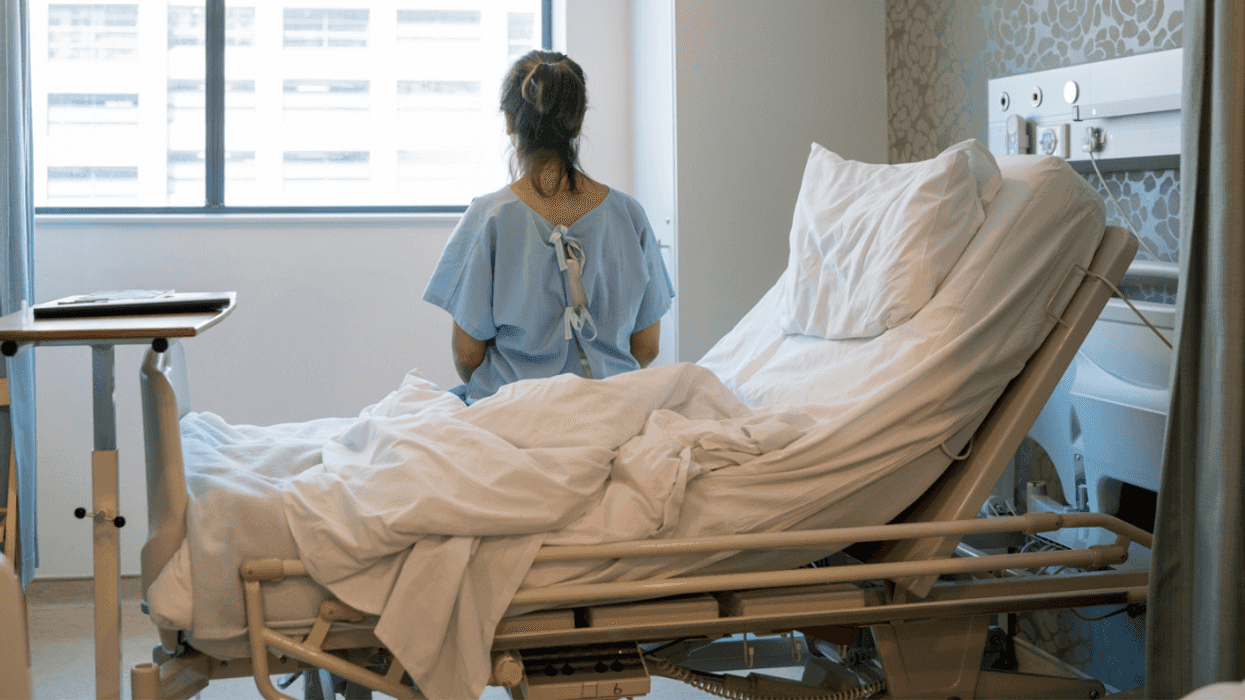 woman seated on hospital bed