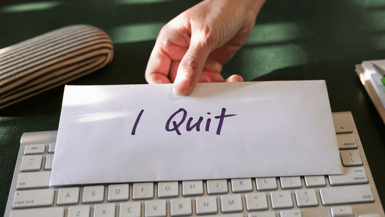 woman setting down letter marked "I quit"
