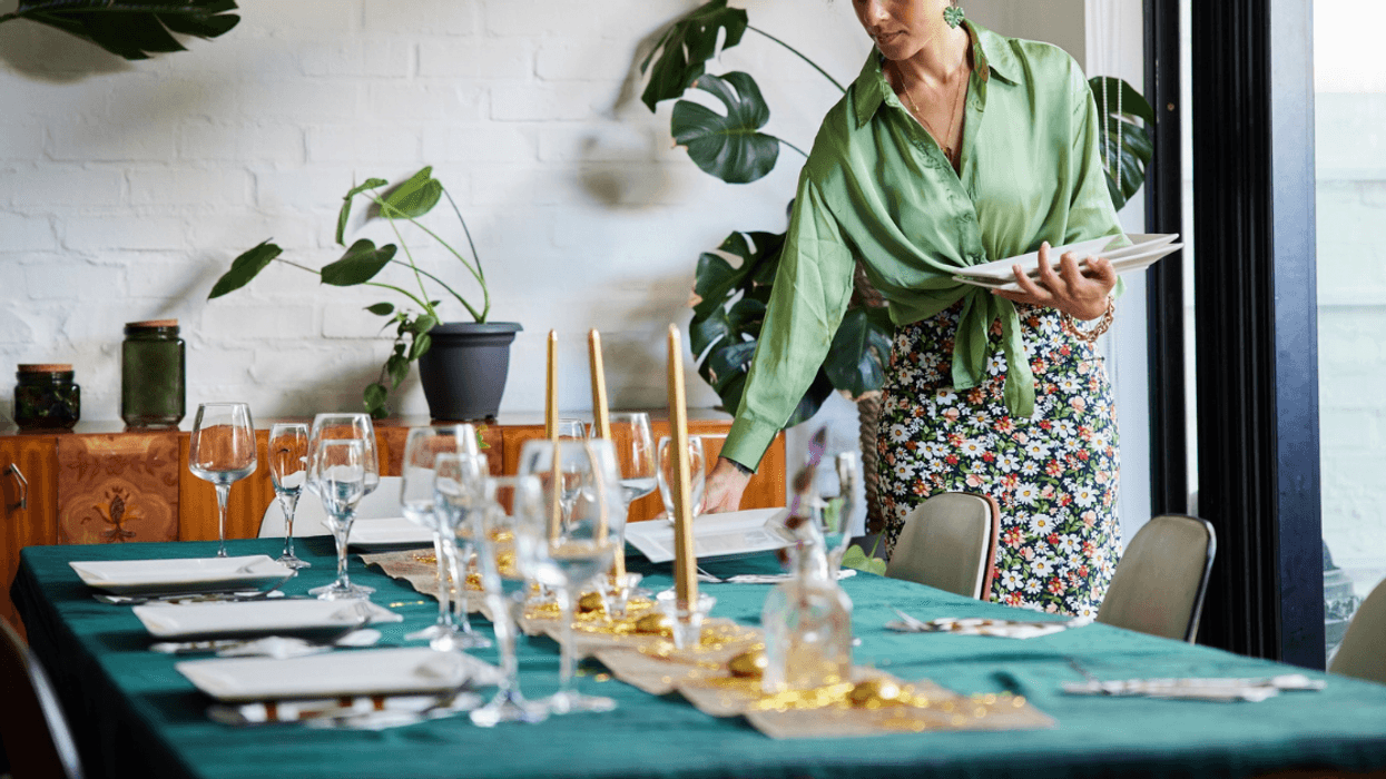 woman setting table for dinner