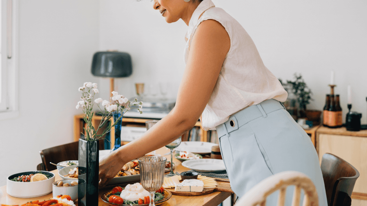 woman setting table for dinner
