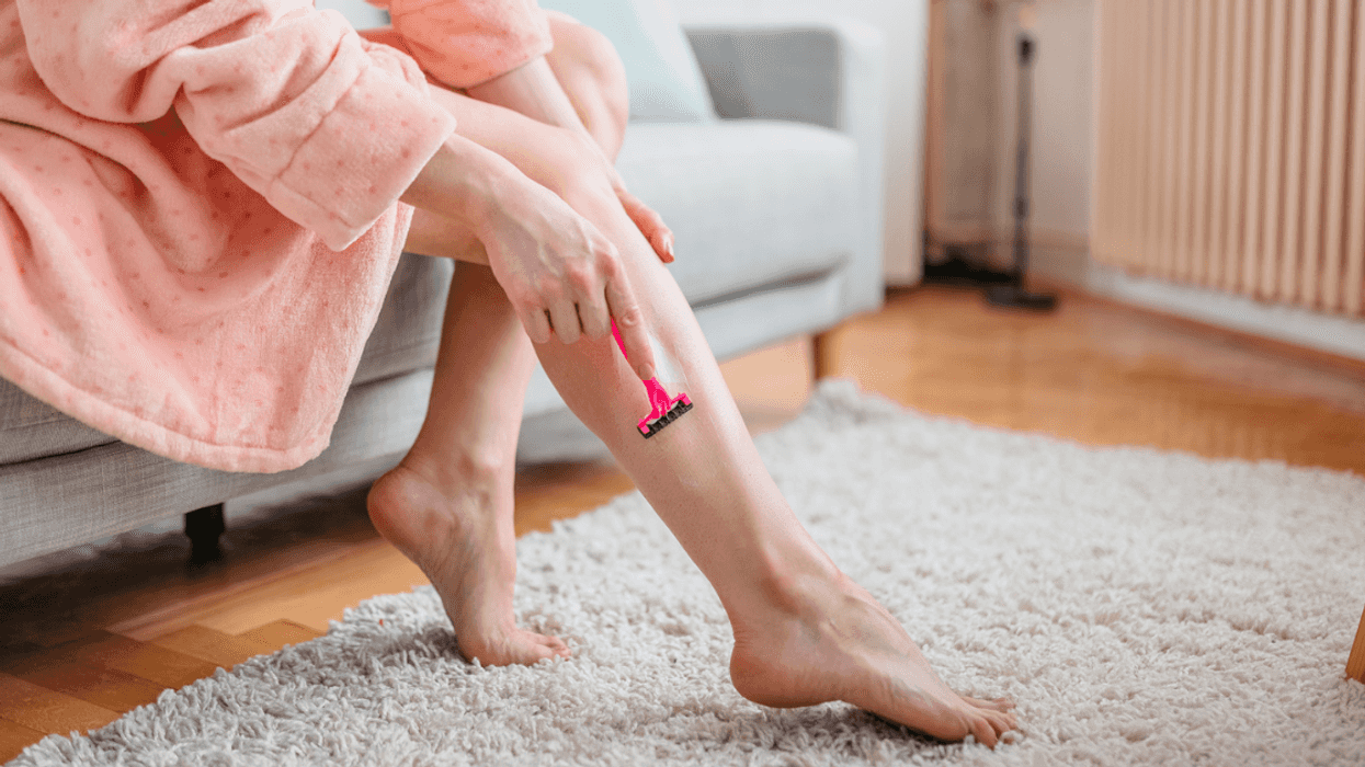 Woman shaving her legs