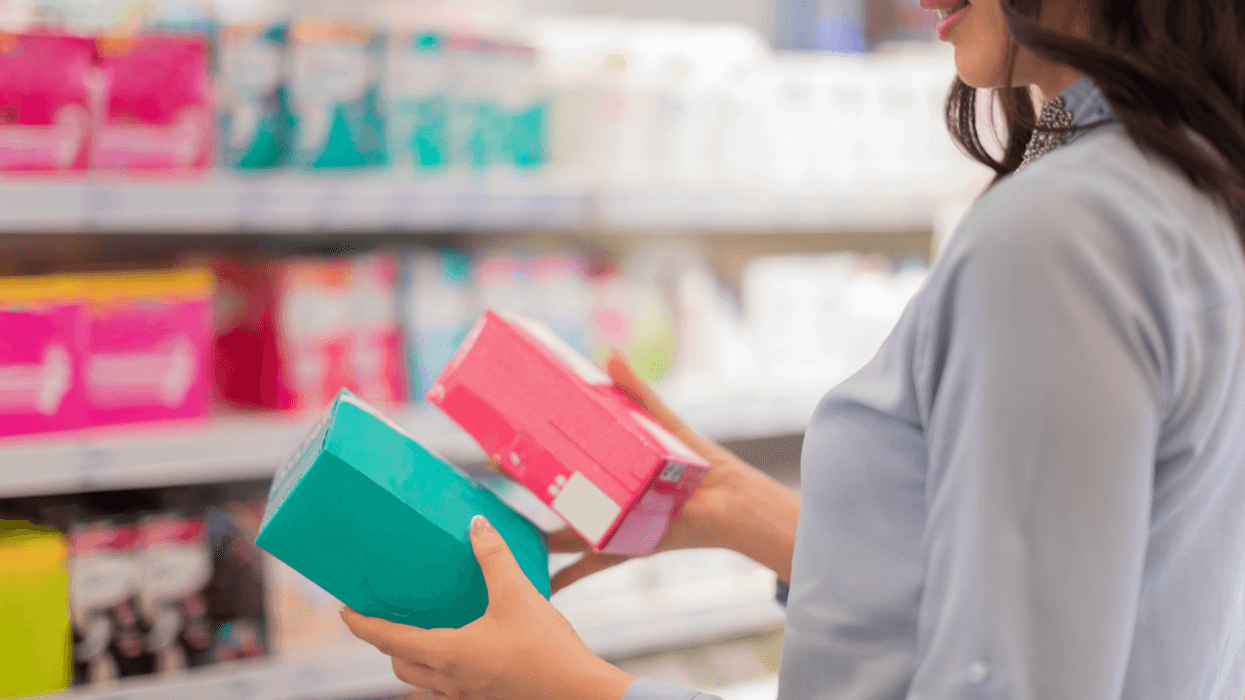 Woman shopping for feminine hygiene products.
