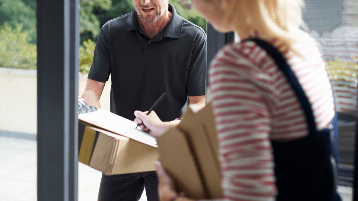 Woman signing for delivery package