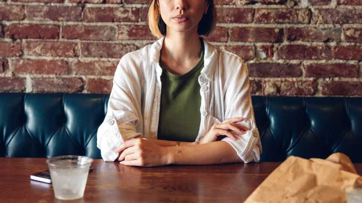Woman sitting alone at restaurant