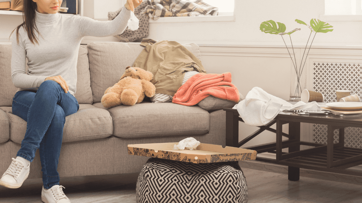 woman sitting in a messy living room
