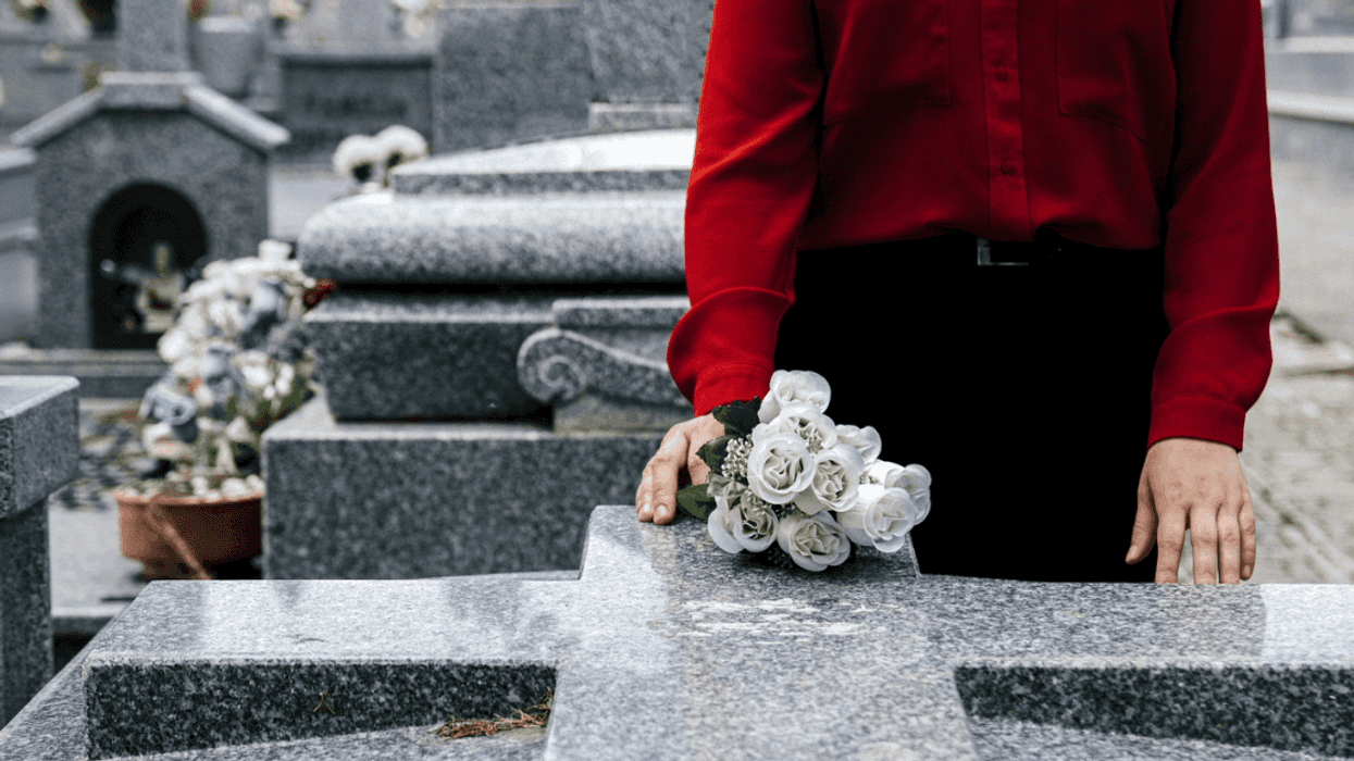 Woman standing at grave