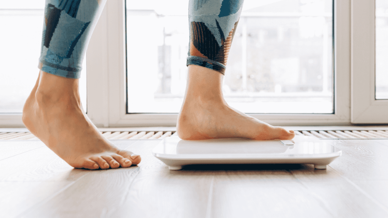 Woman stepping on to a scale