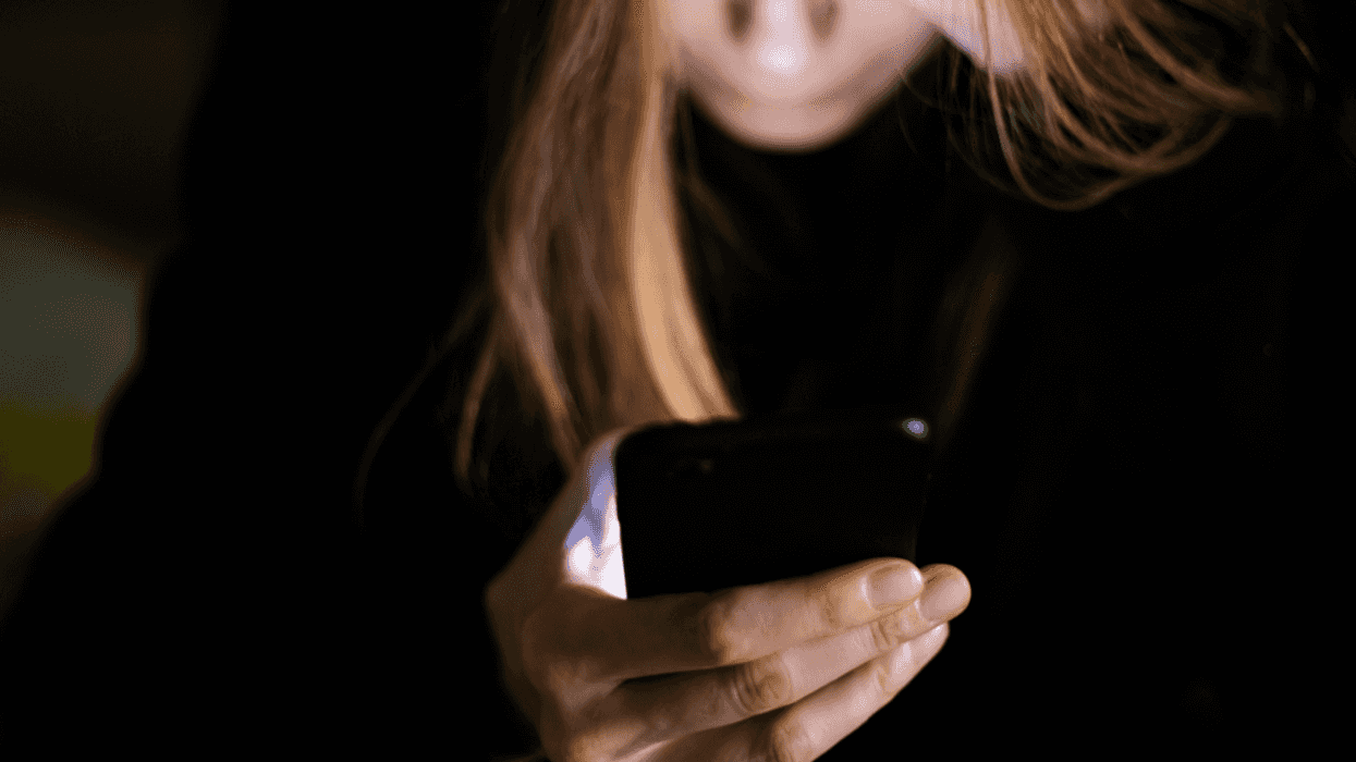 Woman stressed while looking at cell phone