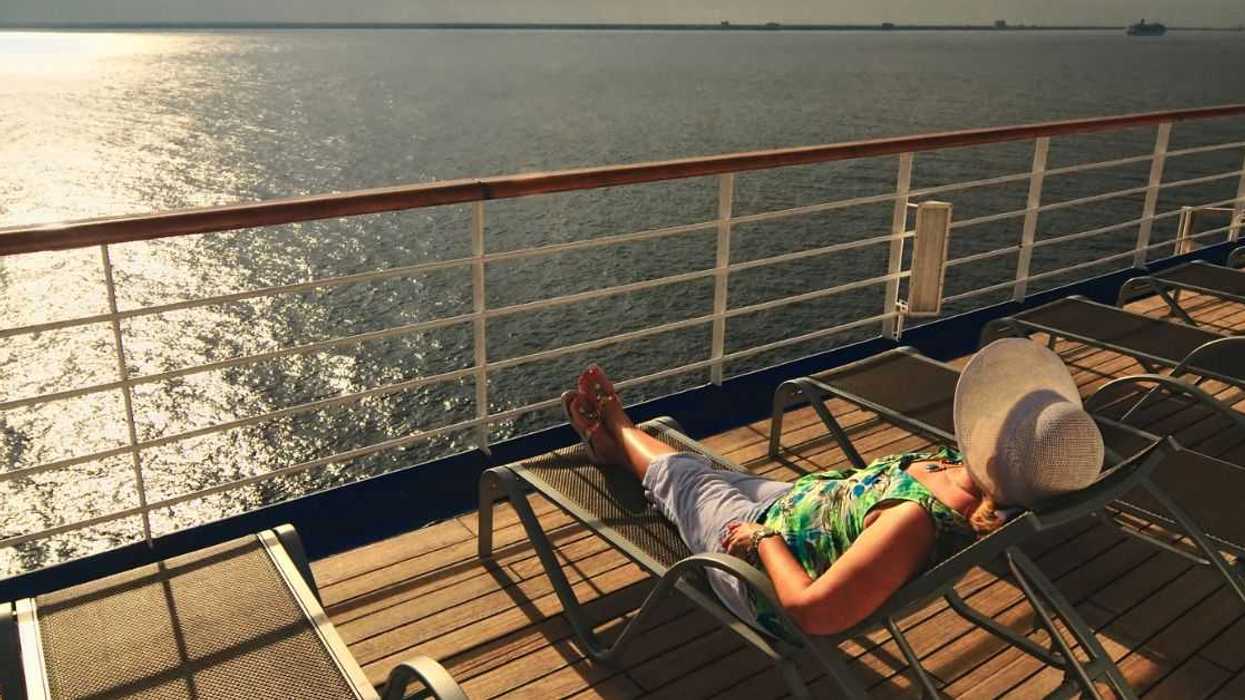Woman sunning on a cruise deck lounge chair