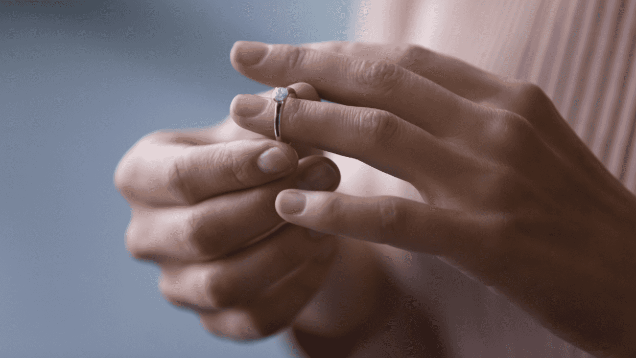 Woman taking off engagement ring