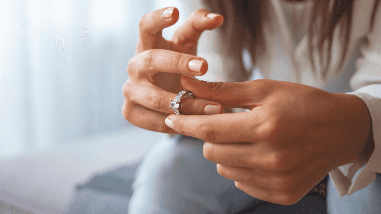 Woman taking off her engagement ring