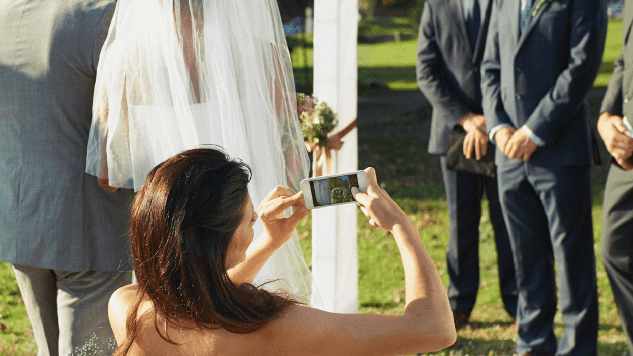 Woman taking photos during wedding ceremony