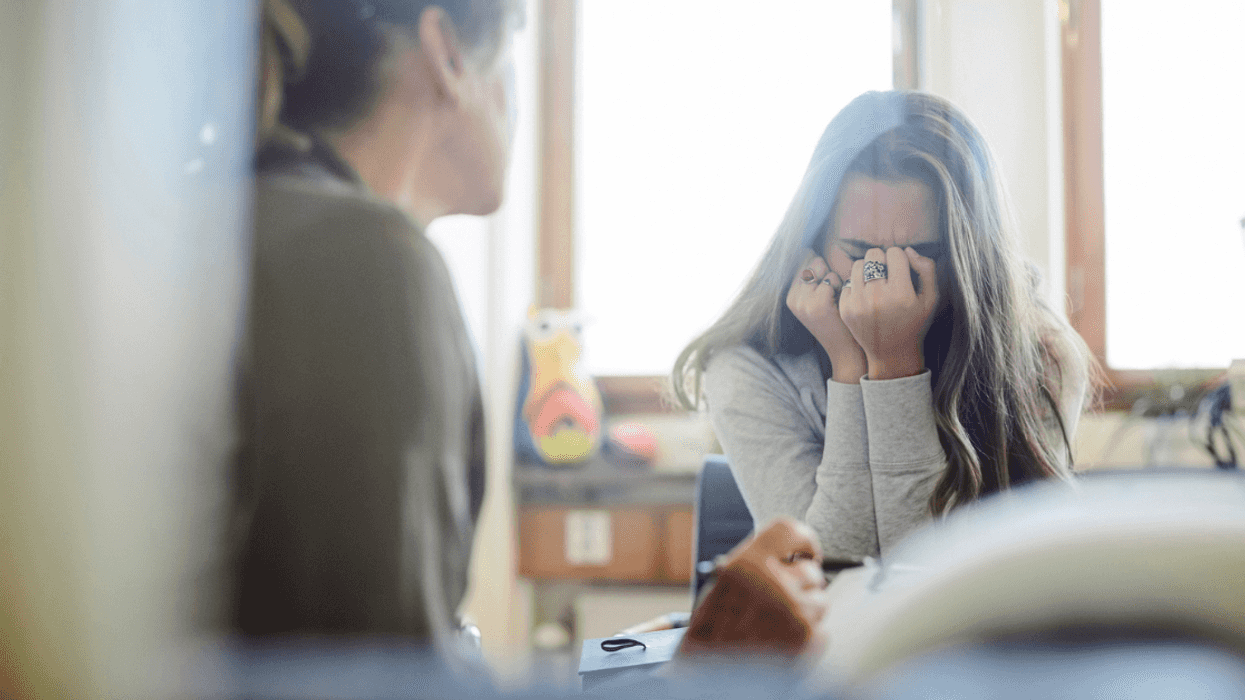 Woman talking to a crying teenage girl.