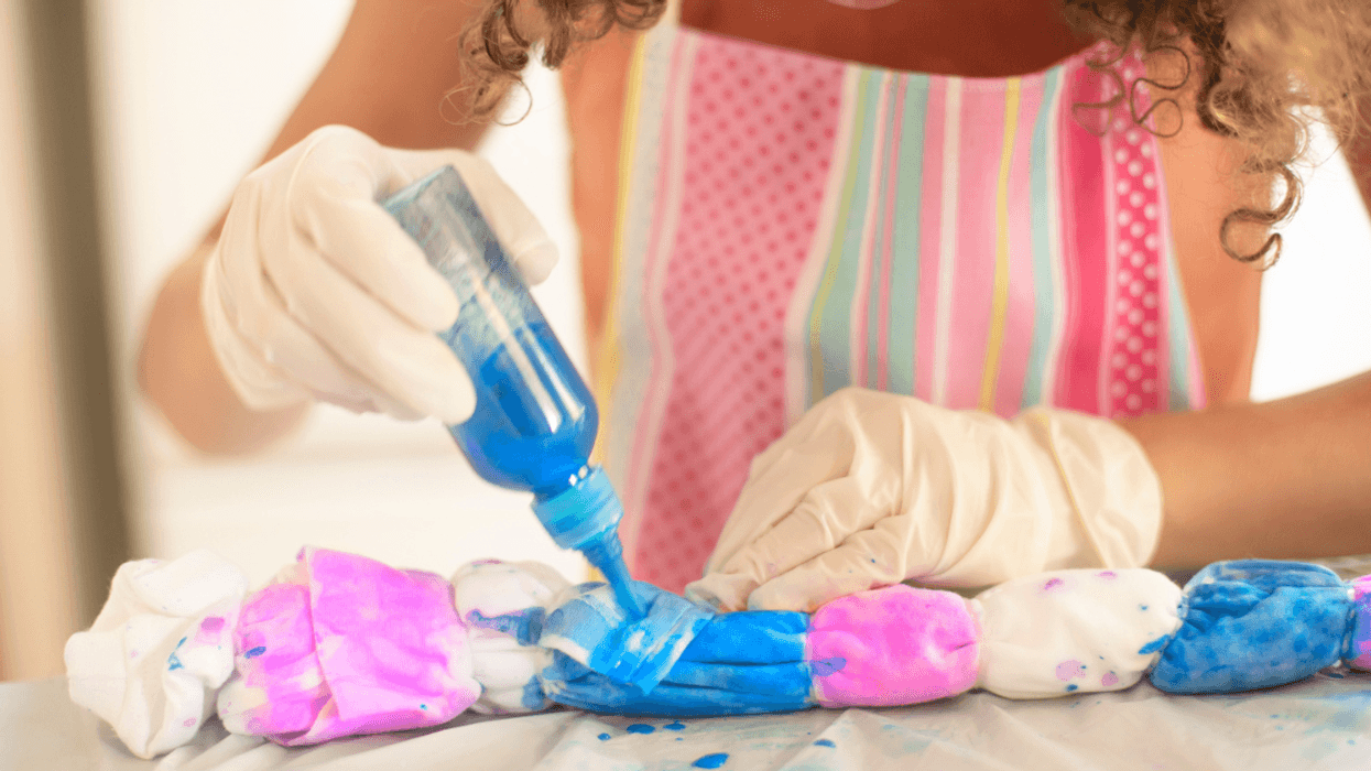 Woman tie-dyeing a dress