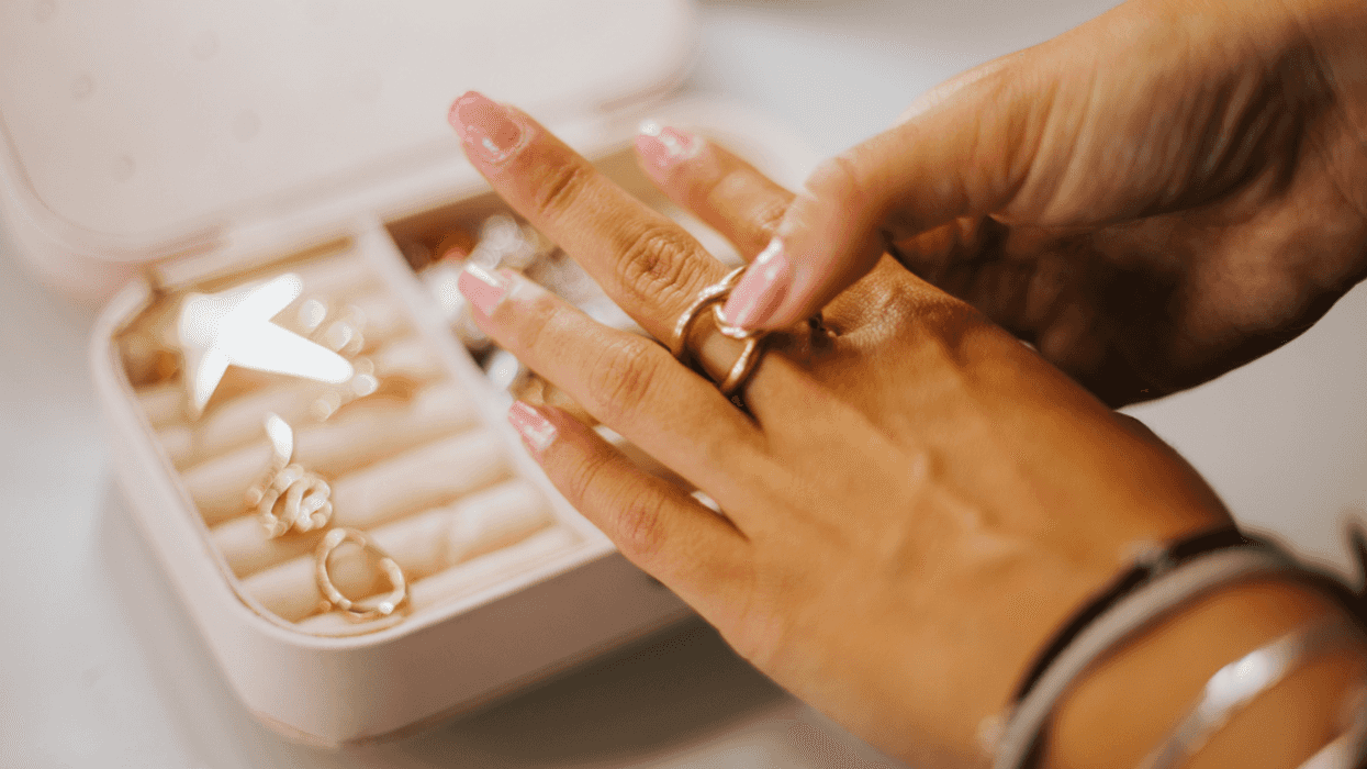 Woman trying on jewelry from jewelry box