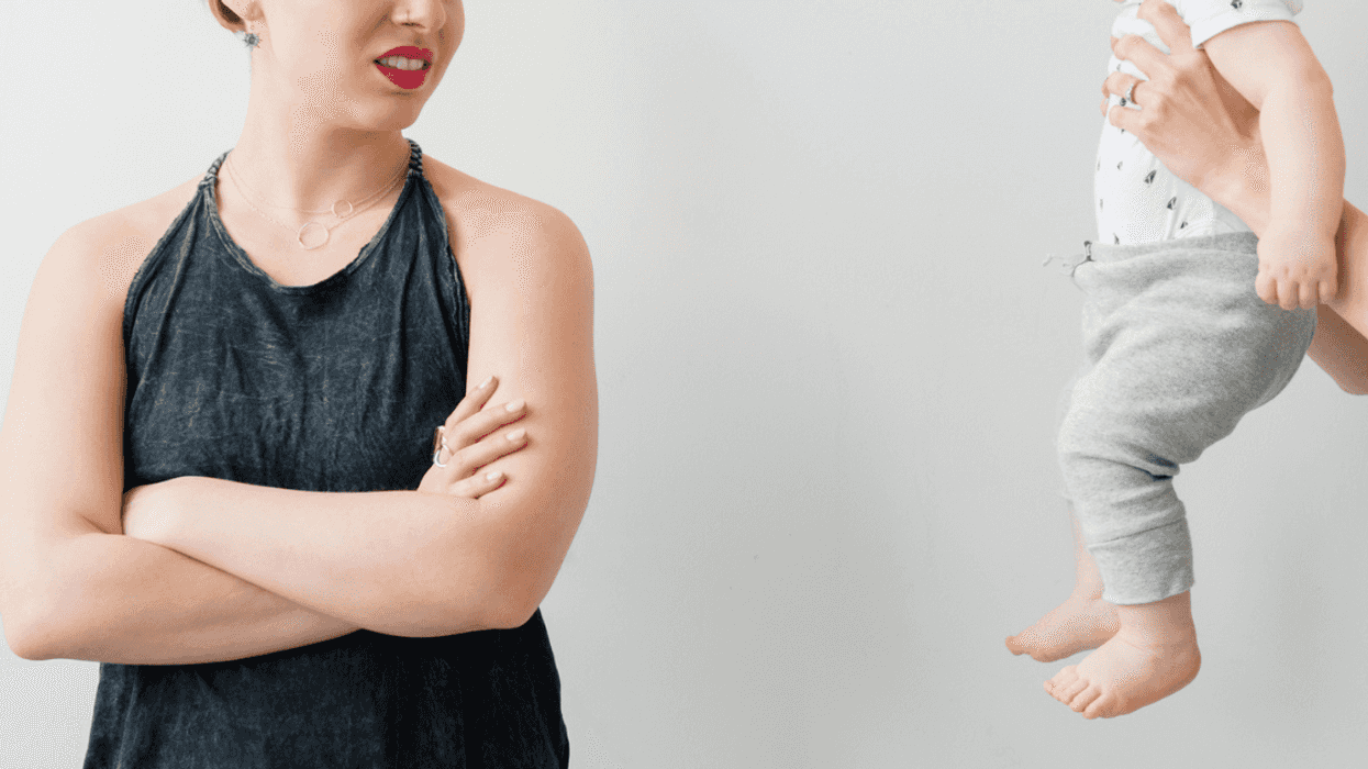 Woman turning away from holding someone's baby