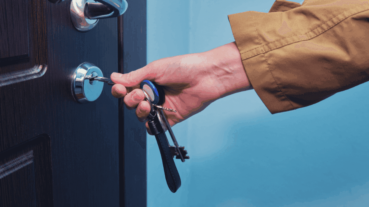 Woman unlocking an apartment door