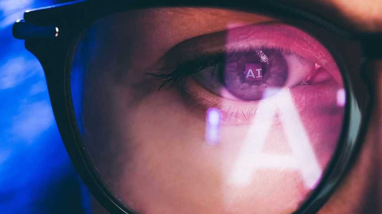 Woman using AI technology with reflection on eyeglasses.